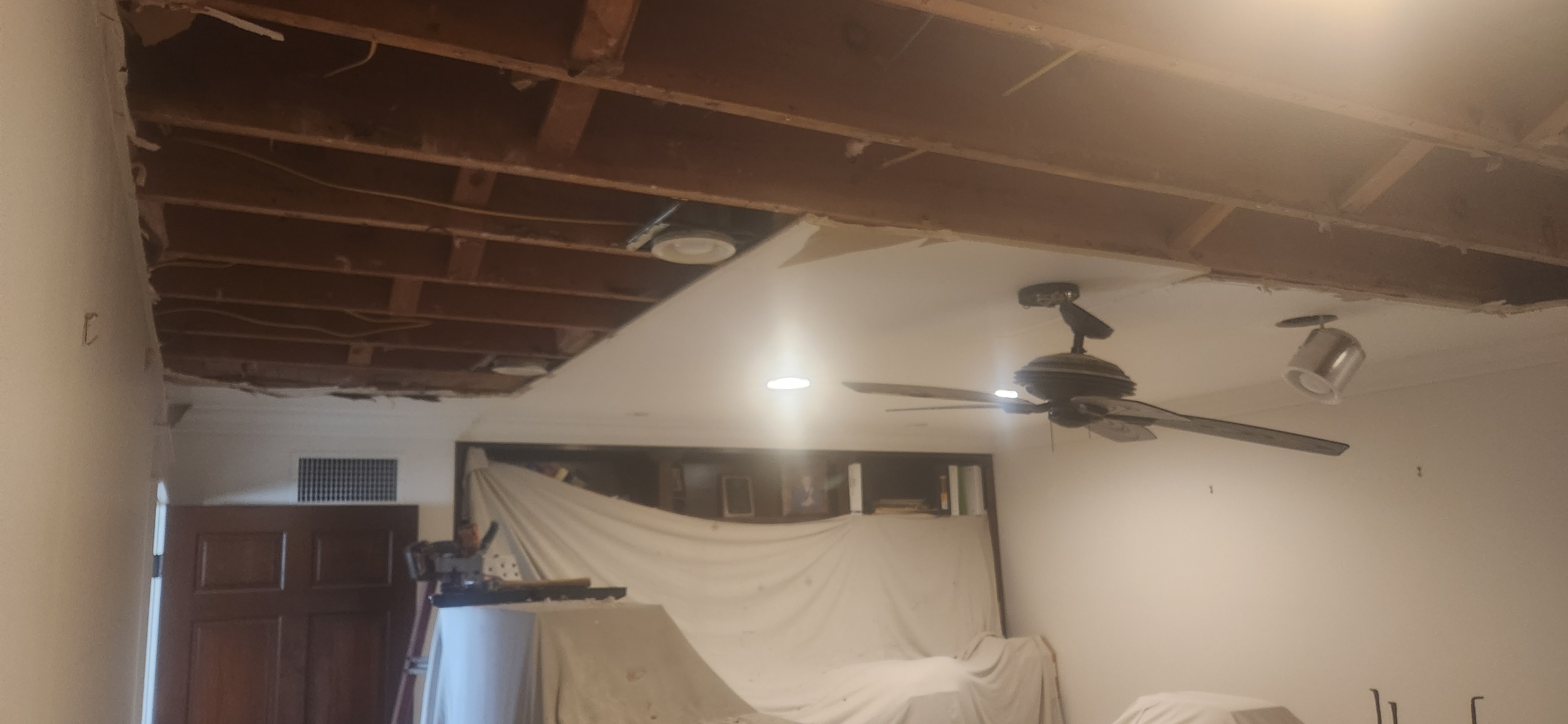 Damaged ceiling drywall prior to patch and repair work