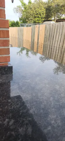 Water-repellent protective seal coat applied to outdoor stone surface